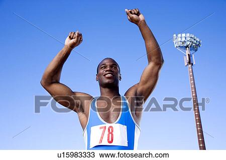 Stock Image - Portrait of an athlete with arm raised. Fotosearch