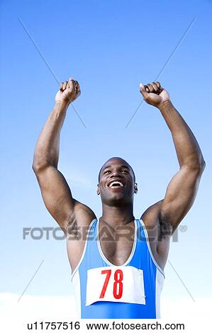 Stock Photograph - Portrait of an athlete with arm raised. Fotosearch
