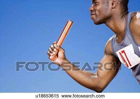 Stock Photography - Relay runner with baton in his hand. Fotosearch