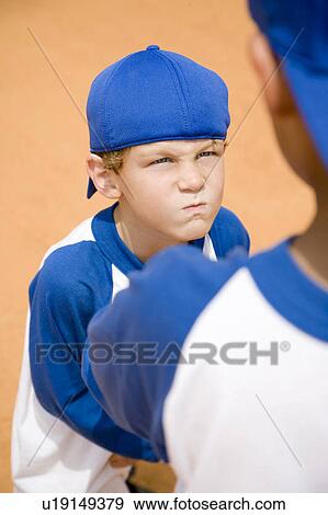 boy glaring at another boy on baseball pitch View Large Photo Image Stock Photo - boy glaring at another boy on baseball pitch. Fotosearch