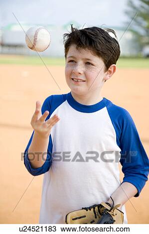 Boy throwing baseball in air View Large Photo Image Stock Image - Boy throwing baseball in air. Fotosearch
