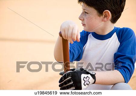 Boy with baseball bat kneeling View Large Photo Image Stock Photo - Boy with baseball bat kneeling. Fotosearch