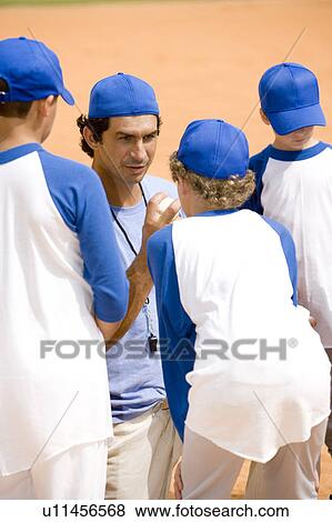 Little league baseball team and coach on pitch View Large Photo Image Stock Photo - Little league baseball team and coach on pitch. Fotosearch