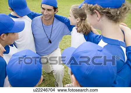 Little league baseball team in huddle with their coach View Large Photo Image Picture - Little league baseball team in huddle with their coach. Fotosearch