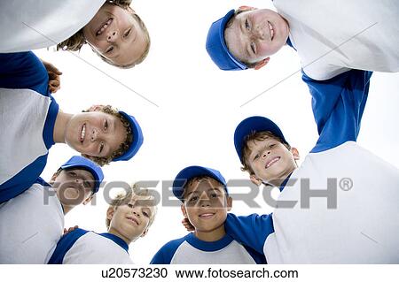 Stock Image - Little league baseball team standing in a circle. Fotosearch