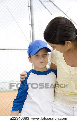 Mother comforting son after baseball game View Large Photo Image Stock Image - Mother comforting son after baseball game. Fotosearch