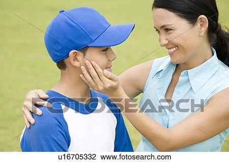 Mother congratulating son after baseball game View Large Photo Image Stock Image - Mother congratulating son after baseball game. Fotosearch