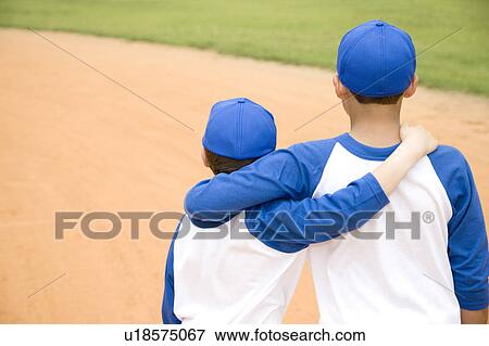 two boys walking away with arms around each other's shoulders View Large Photo Image Stock Photo - two boys walking away with arms around each other's shoulders. Fotosearch
