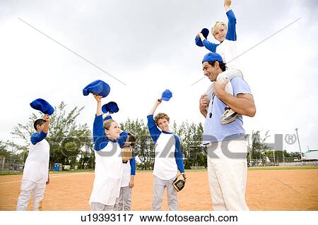 Young boy being carried on the shoulders of baseball coach View Large Photo Image Stock Photo - Young boy being carried on the shoulders of baseball coach. Fotosearch