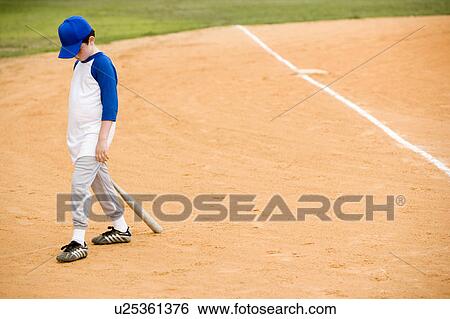 Young boy walking off baseball pitch View Large Photo Image Stock Photograph - Young boy walking off baseball pitch. Fotosearch