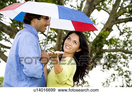 couple with umbrella walking in the park View Large Photo Image Stock Photo - couple with umbrella walking in the park. Fotosearch