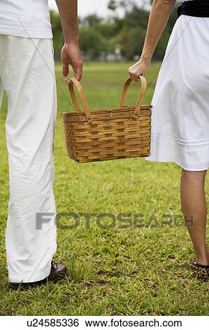 cropped image couple walking with picnic basket View Large Photo Image Stock Photograph - cropped image couple walking with picnic basket. Fotosearch