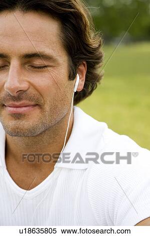 Stock Photography - Cropped portrait man with earphones. Fotosearch