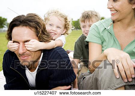 Stock Photo - Family having fun in the park. Fotosearch