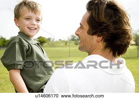 father holding son in the park View Large Photo Image Stock Image - father holding son in the park. Fotosearch
