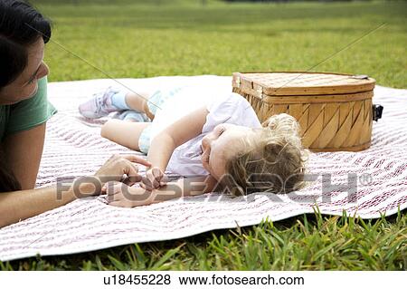mother and daughter lying on picnic rug View Large Photo Image Stock Photo - mother and daughter lying on picnic rug. Fotosearch