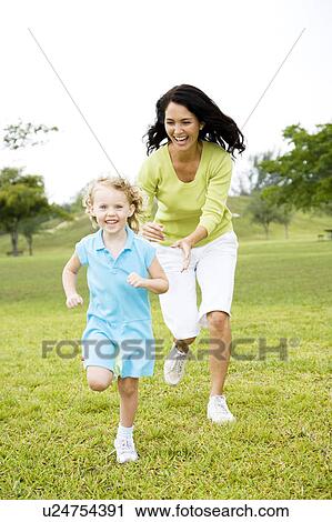 mother and daughter playing in the park View Large Photo Image Stock Image - mother and daughter playing in the park. Fotosearch