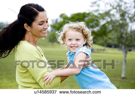 mother and daughter playing in the park View Large Photo Image Stock Photo - mother and daughter playing in the park. Fotosearch