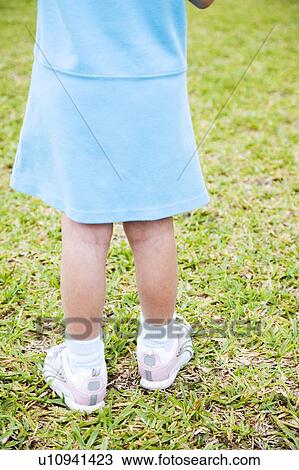 Rear view cropped little girl standing on the grass View Large Photo Image Stock Image - Rear view cropped little girl standing on the grass. Fotosearch