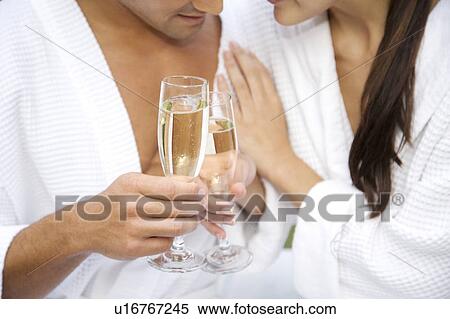 Stock Photography - Couple celebrating with champagne . Fotosearch