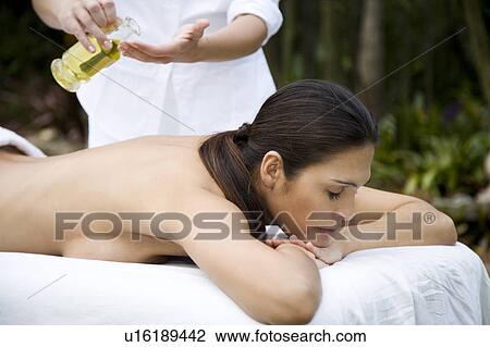 Hispanic woman receiving a massage in a tropical setting View Large Photo Image Stock Image - Hispanic woman receiving a massage in a tropical setting. Fotosearch