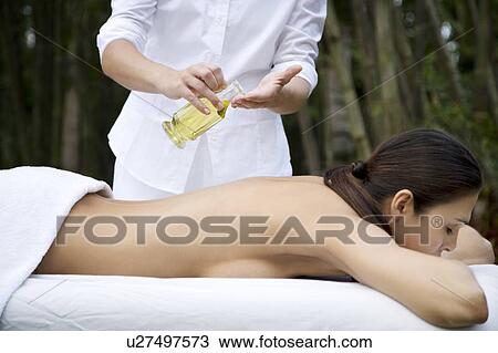 Hispanic woman receiving a massage in a tropical setting View Large Photo Image Stock Image - Hispanic woman receiving a massage in a tropical setting. Fotosearch
