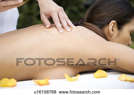Hispanic woman receiving a massage in a tropical setting View Large Photo Image Stock Photo - Hispanic woman receiving a massage in a tropical setting. Fotosearch