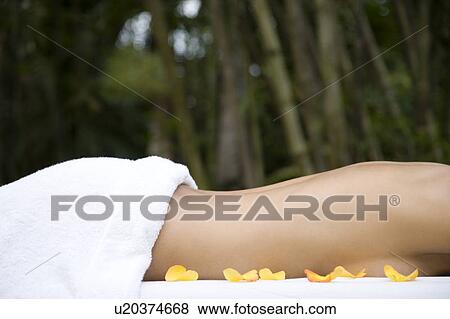 Hispanic woman receiving a massage in a tropical setting View Large Photo Image Stock Photo - Hispanic woman receiving a massage in a tropical setting. Fotosearch