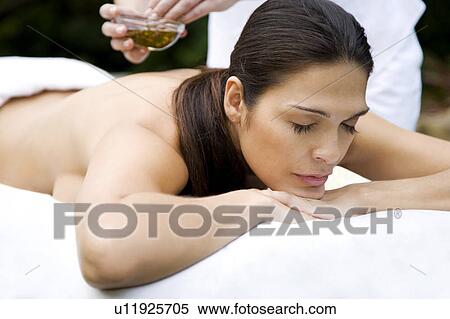 Hispanic woman receiving a massage in a tropical setting View Large Photo Image Stock Photography - Hispanic woman receiving a massage in a tropical setting. Fotosearch