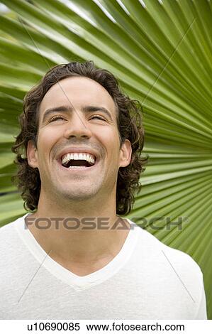 Portrait of a laughing adult man in a tropical garden. View Large Photo Image Stock Photography - Portrait of a laughing adult man in a tropical garden. . Fotosearch