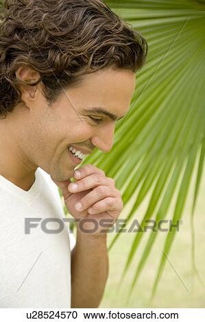 Portrait of a smiling adult man in a tropical garden. View Large Photo Image Stock Image - Portrait of a smiling adult man in a tropical garden. . Fotosearch