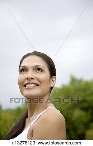 Portrait of a smiling Hispanic woman outside. View Large Photo Image Stock Image - Portrait of a smiling Hispanic woman outside. . Fotosearch