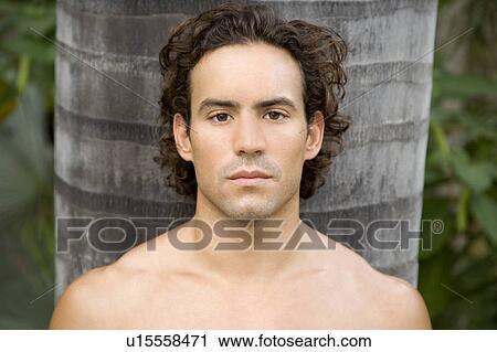 Portrait of a toned muscular man standing in a garden View Large Photo Image Stock Image - Portrait of a toned muscular man standing in a garden . Fotosearch