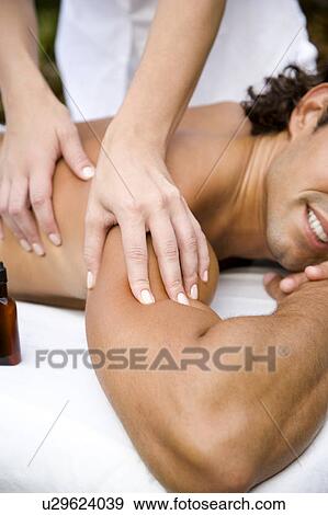 Smiling man receiving a massage close up View Large Photo Image Stock Photo - Smiling man receiving a massage close up. Fotosearch