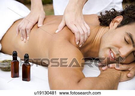 Smiling man receiving a massage View Large Photo Image Stock Image - Smiling man receiving a massage . Fotosearch