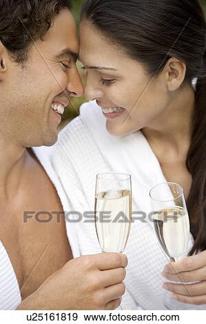 Woman and a man celebrating with champagne and being affectionate View Large Photo Image Stock Photo - Woman and a man celebrating with champagne and being affectionate . Fotosearch