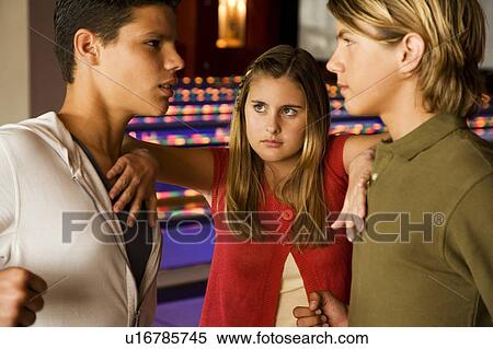 Argument between teenage boys in a bowling alley, girl mediating between them View Large Photo Image Stock Photography - Argument between teenage boys in a bowling alley, girl mediating between them. Fotosearch