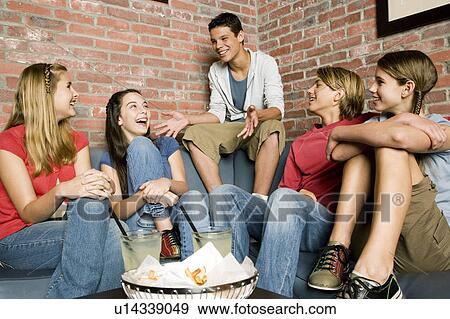 Stock Photo - Group of teenage friends at a bowling alley, laughing and joking. Fotosearch