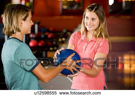 Teenage boy and girl in a bowling alley View Large Photo Image Stock Photography - Teenage boy and girl in a bowling alley. Fotosearch