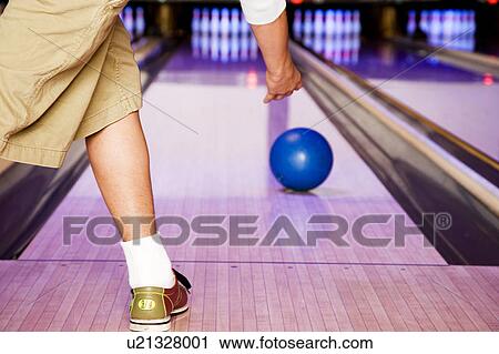 Teenage boy in a bowling alley, rolling the ball View Large Photo Image Stock Image - Teenage boy in a bowling alley, rolling the ball. Fotosearch