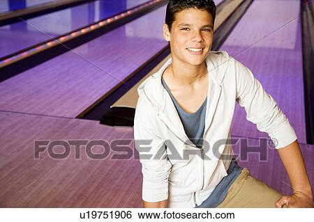 Teenage boy in a bowling alley View Large Photo Image Stock Photograph - Teenage boy in a bowling alley. Fotosearch