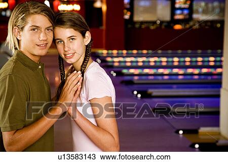 Teenage couple in a bowling alley View Large Photo Image Stock Image - Teenage couple in a bowling alley. Fotosearch