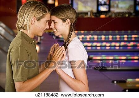 Teenage couple in a bowling alley View Large Photo Image Stock Image - Teenage couple in a bowling alley. Fotosearch