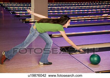 Teenage girl in bowling alley, rolling the ball View Large Photo Image Stock Image - Teenage girl in bowling alley, rolling the ball. Fotosearch