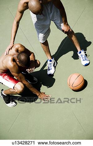 Two men playing on an outdoor basketball court View Large Photo Image Stock Image - Two men playing on an outdoor basketball court . Fotosearch