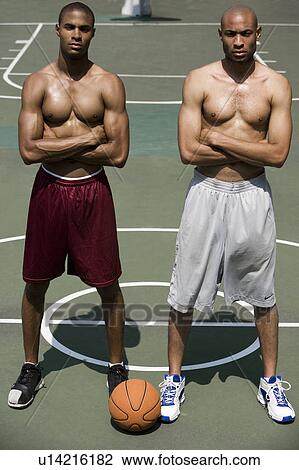 Two Young African American standing side by side on an urban basketball court View Large Photo Image Stock Image - Two Young African American standing side by side on an urban basketball court. Fotosearch