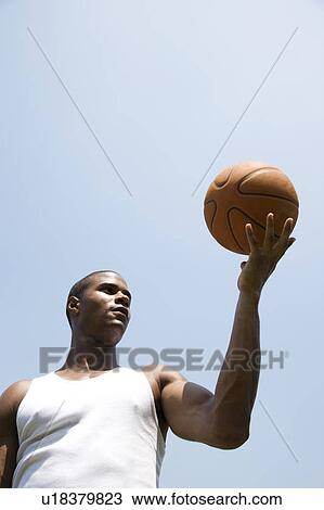 Young African American man holding a basketball View Large Photo Image Stock Image - Young African American man holding a basketball. Fotosearch