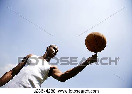 Young African American man spinning a basketball on his finger View Large Photo Image Stock Photo - Young African American man spinning a basketball on his finger. Fotosearch