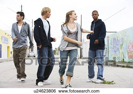 Group of teenagers running down an urban street View Large Photo Image Stock Photograph - Group of teenagers running down an urban street . Fotosearch