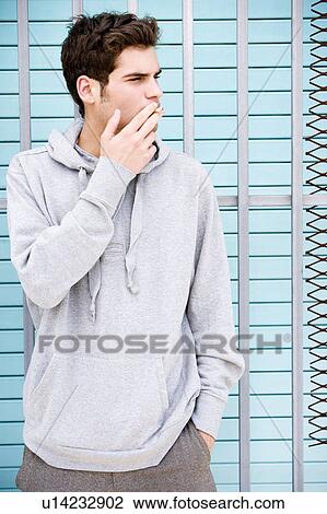 Portrait of a moody young man smoking View Large Photo Image Stock Image - Portrait of a moody young man smoking. Fotosearch